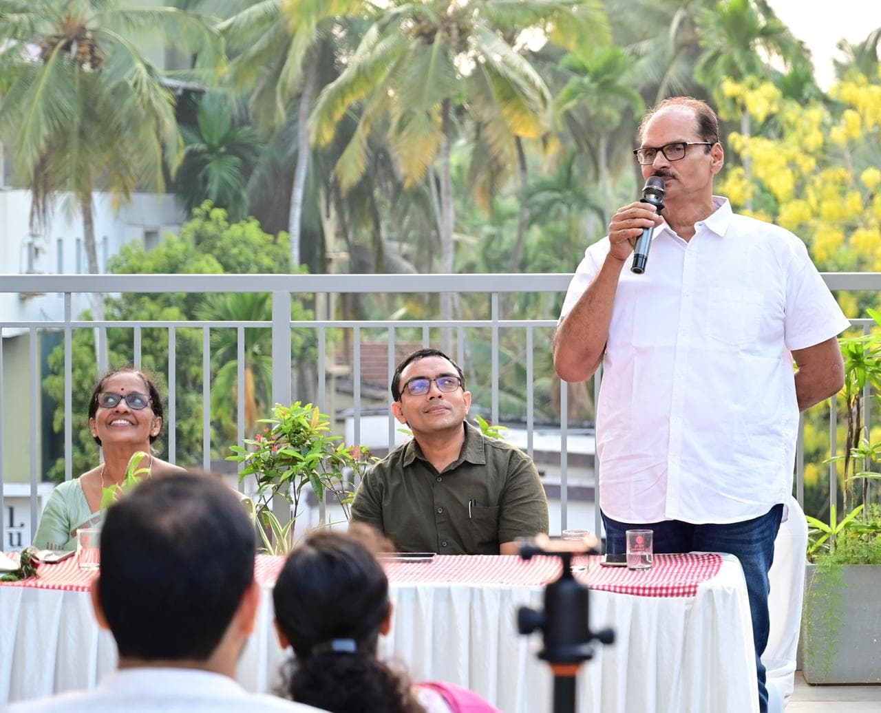 Speaker addressing the crowd from the front table