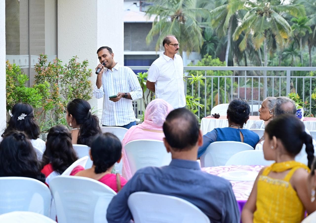 Resident speaking to the audience while others listen