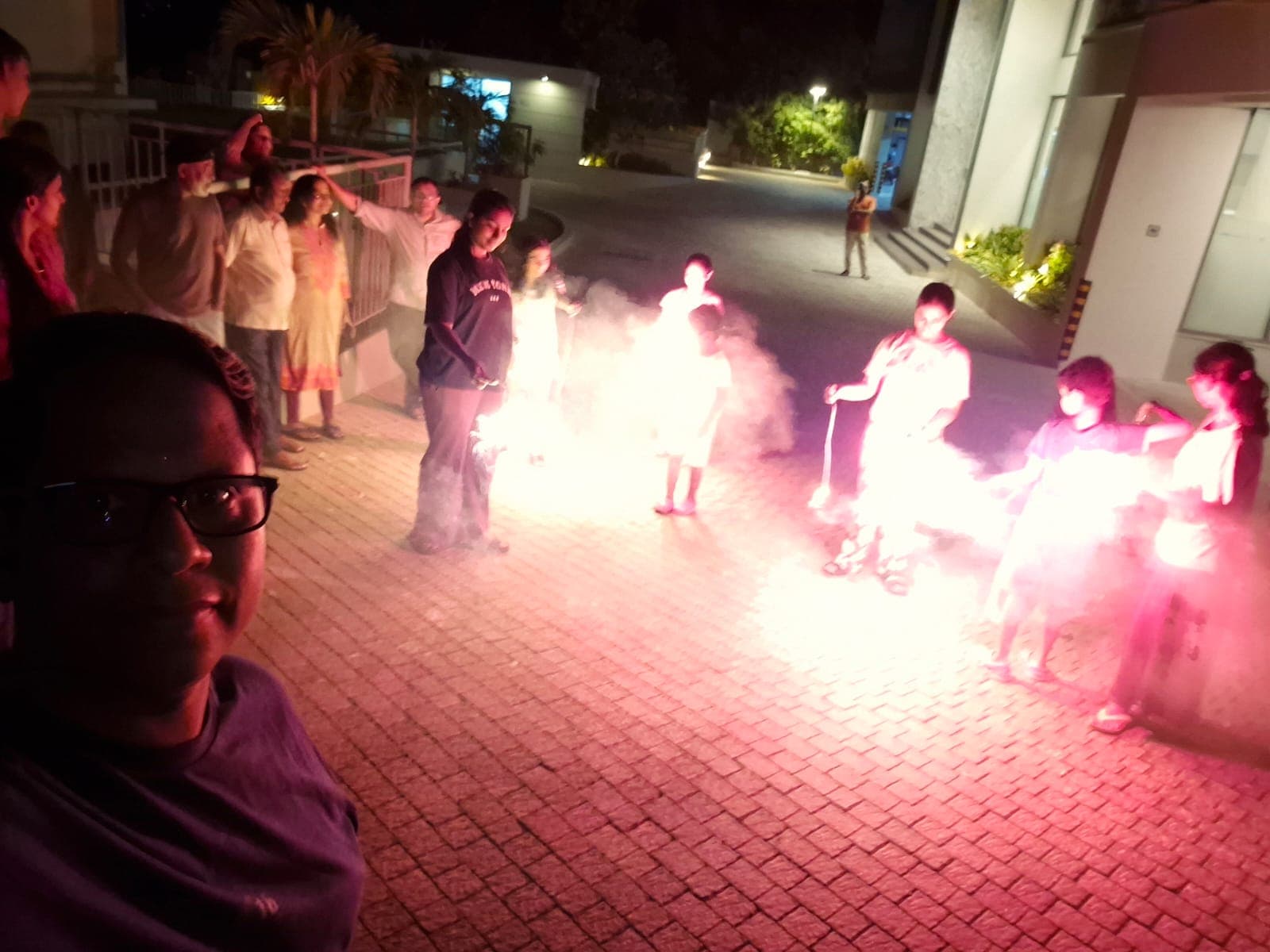 Residents standing in a circle with sparklers during the Vishu celebration
